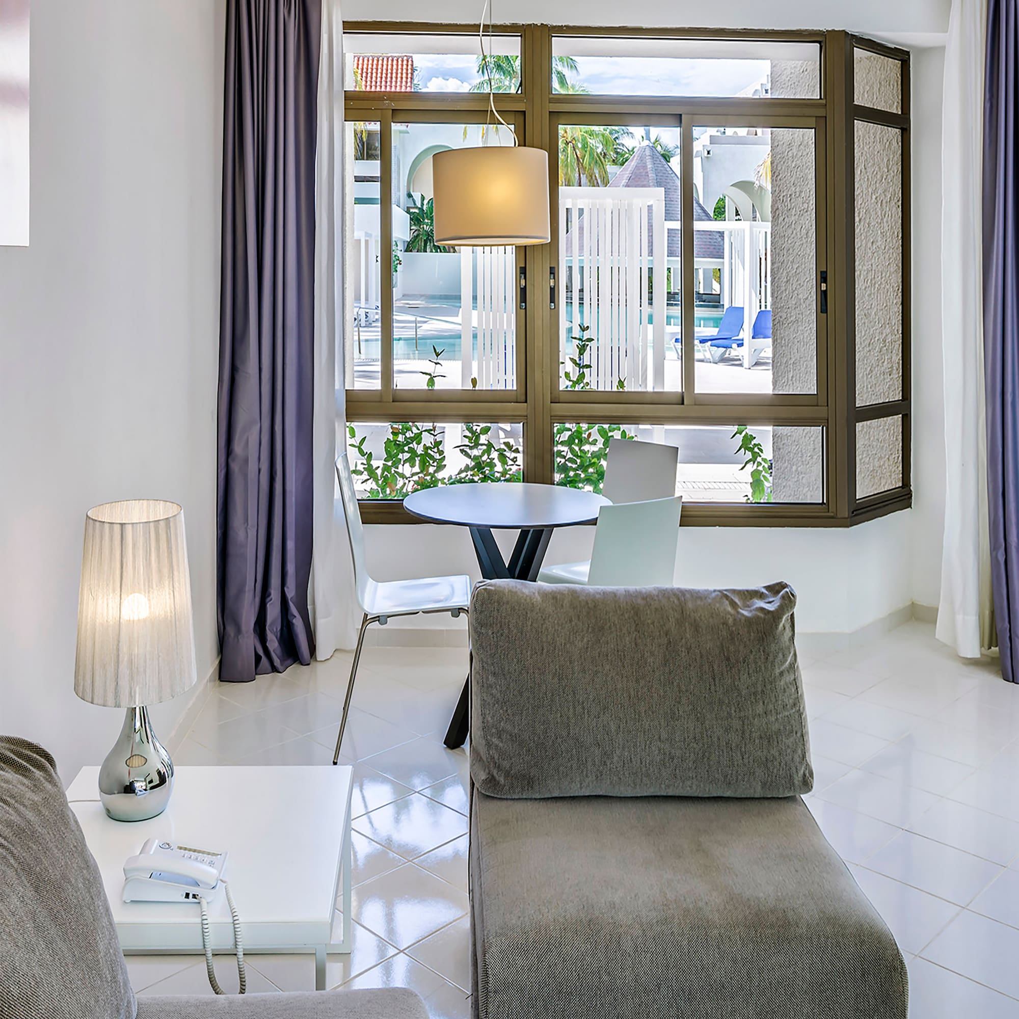 a living room with a table and chairs