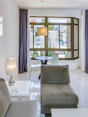 a living room with a table and chairs