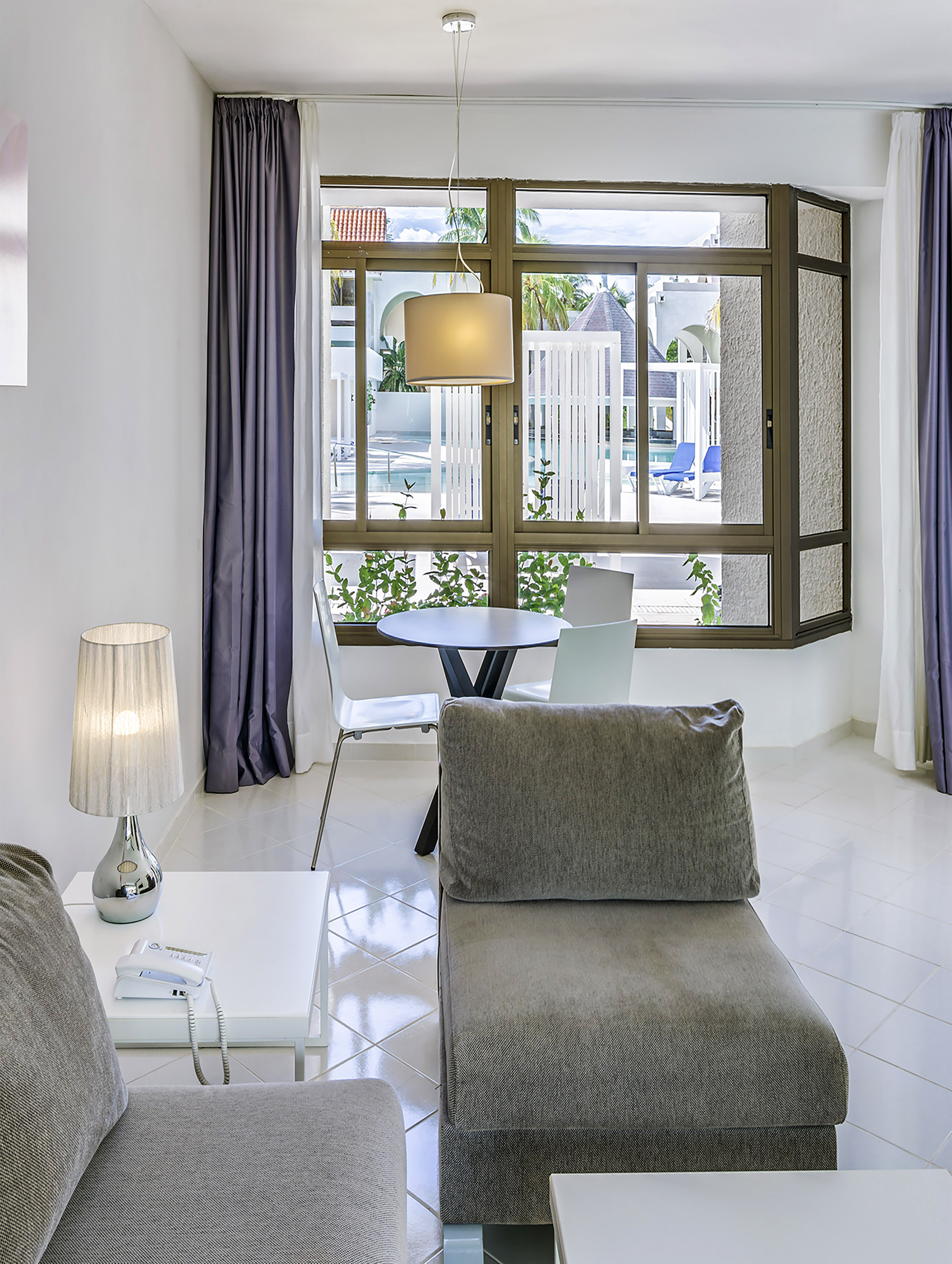 a living room with a table and chairs