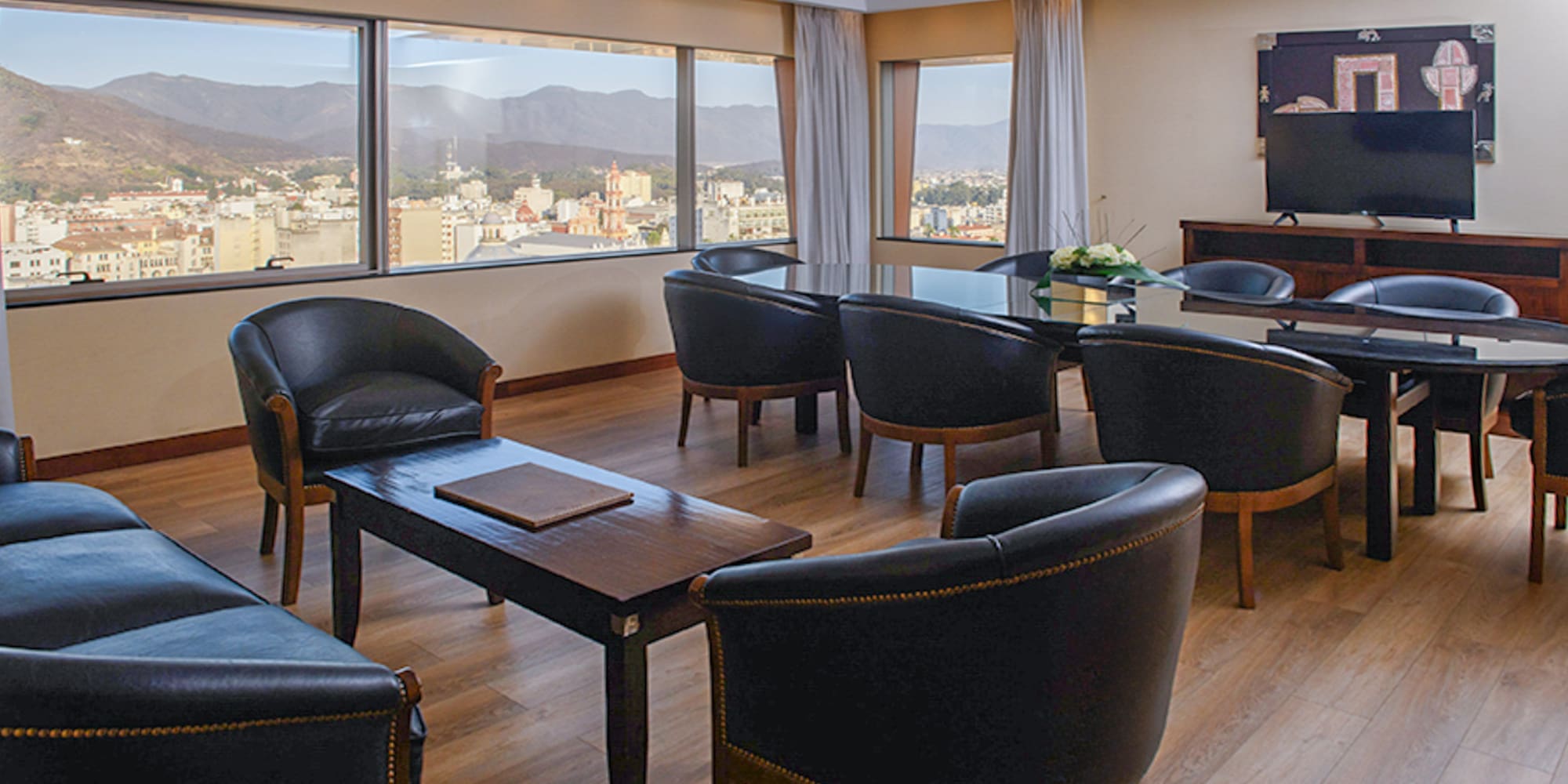 a room with a television and chairs