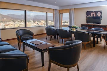 a room with a television and chairs