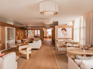 a room with white furniture and a poster