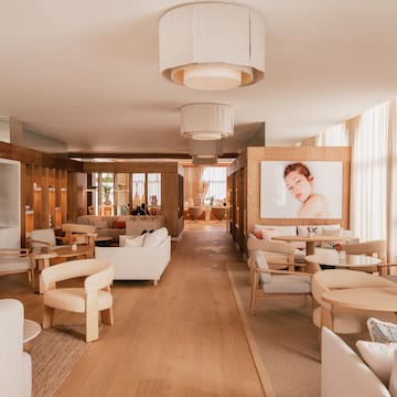 a room with white furniture and a poster