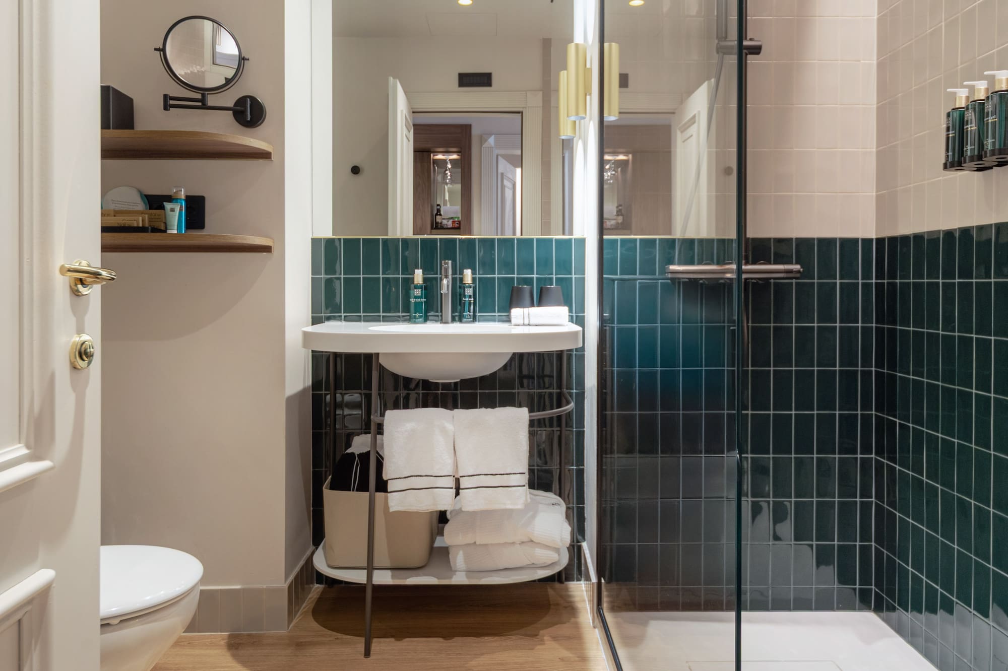 a bathroom with a glass shower door and a sink