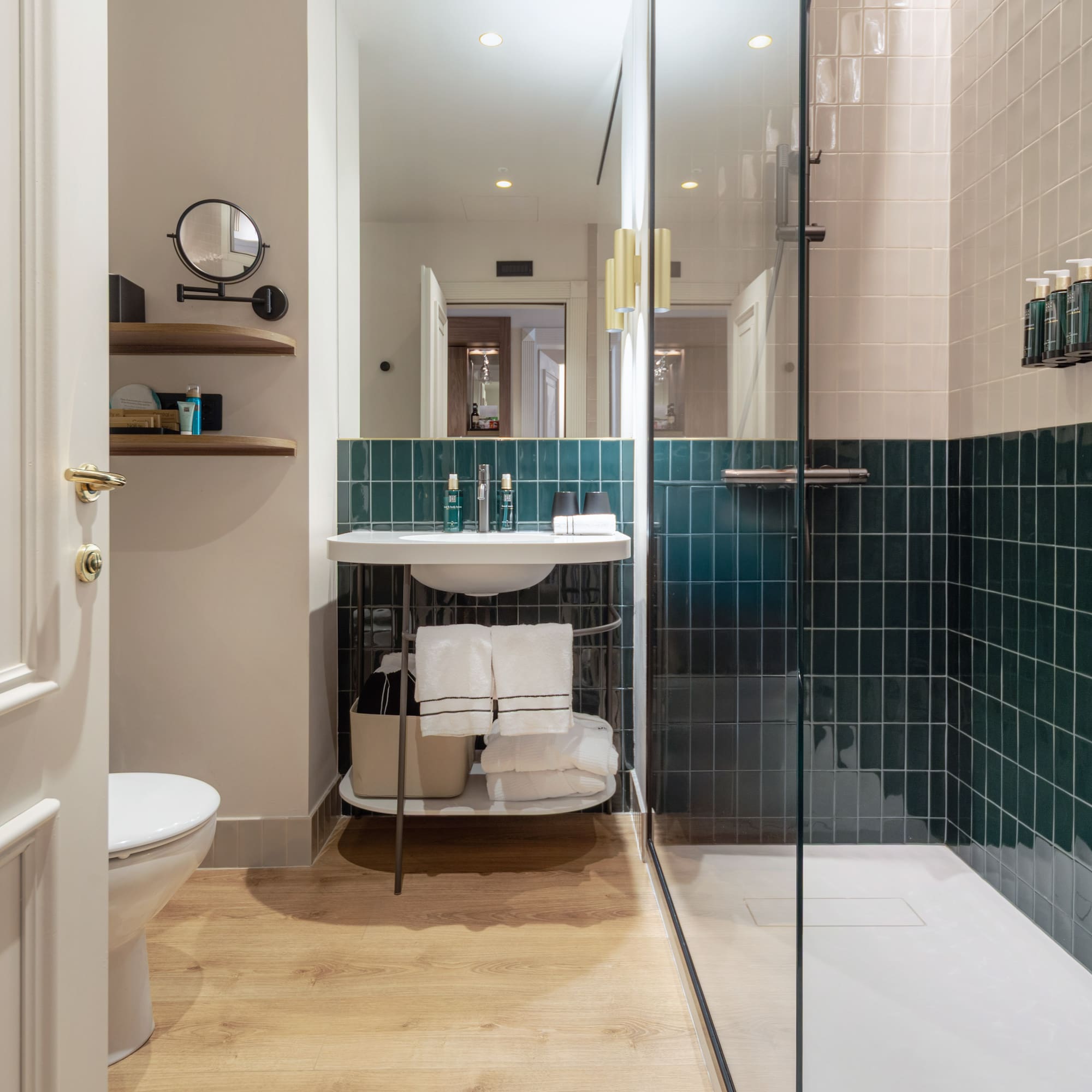 a bathroom with a glass shower door and a sink