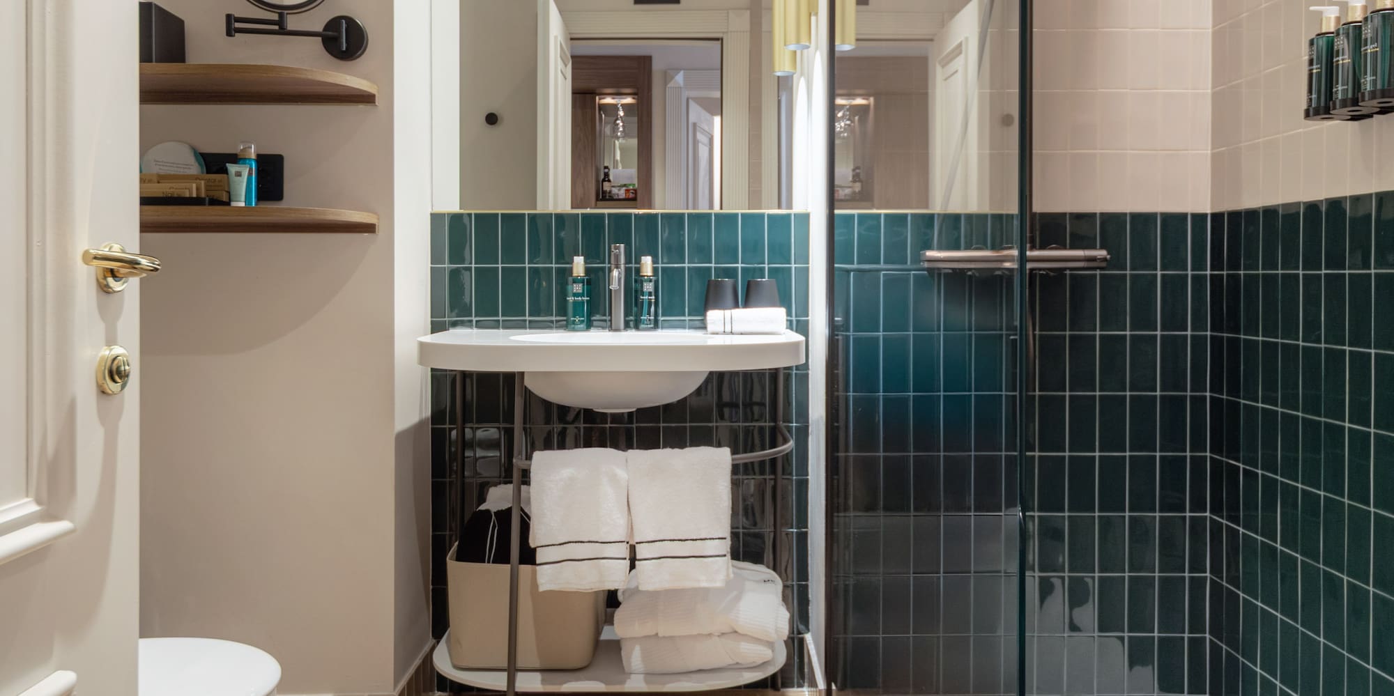 a bathroom with a glass shower door and a sink