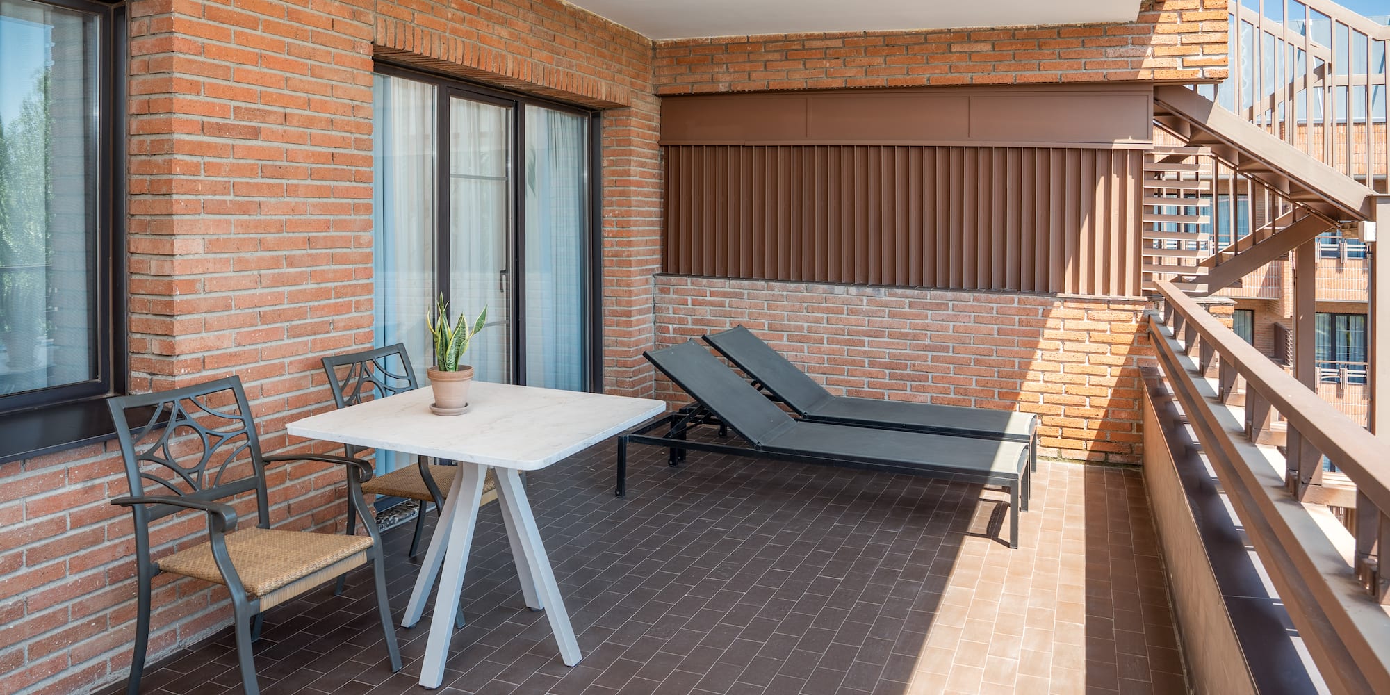 a patio with chairs and a table