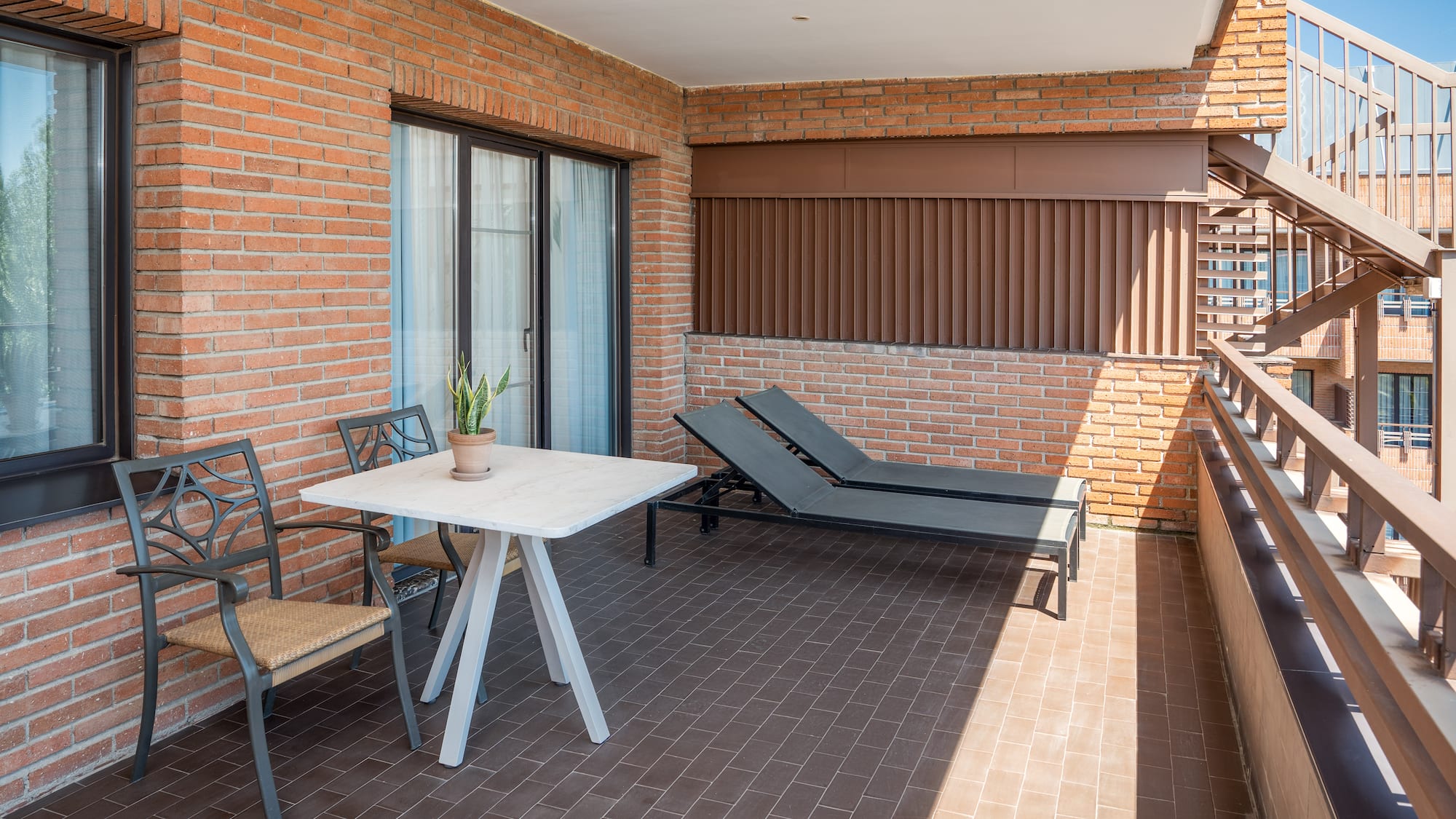 a patio with chairs and a table