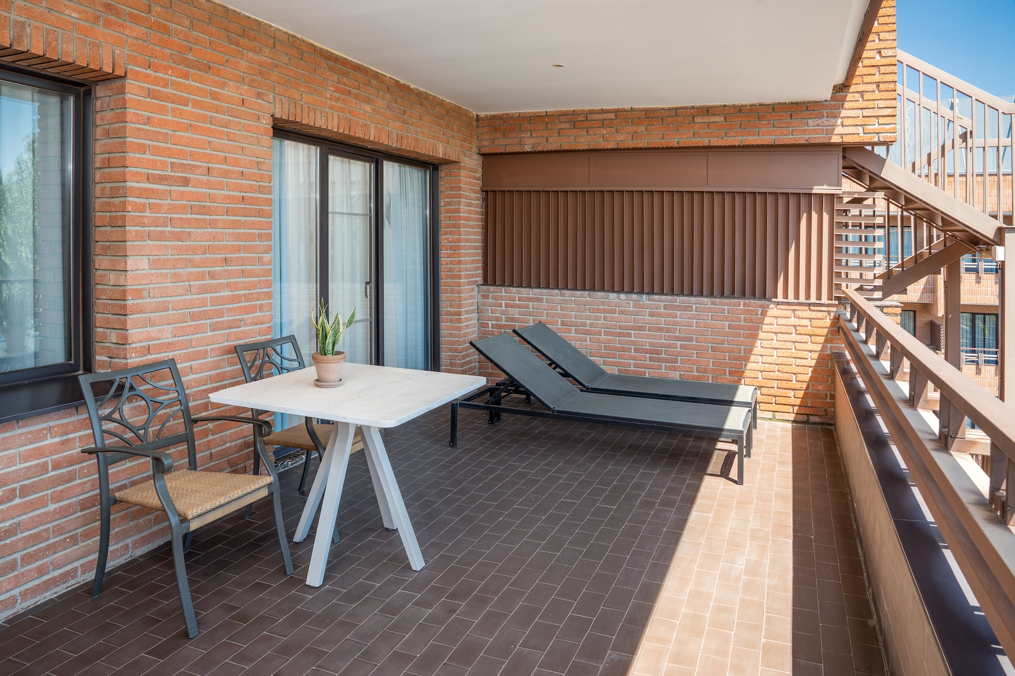 a patio with chairs and a table