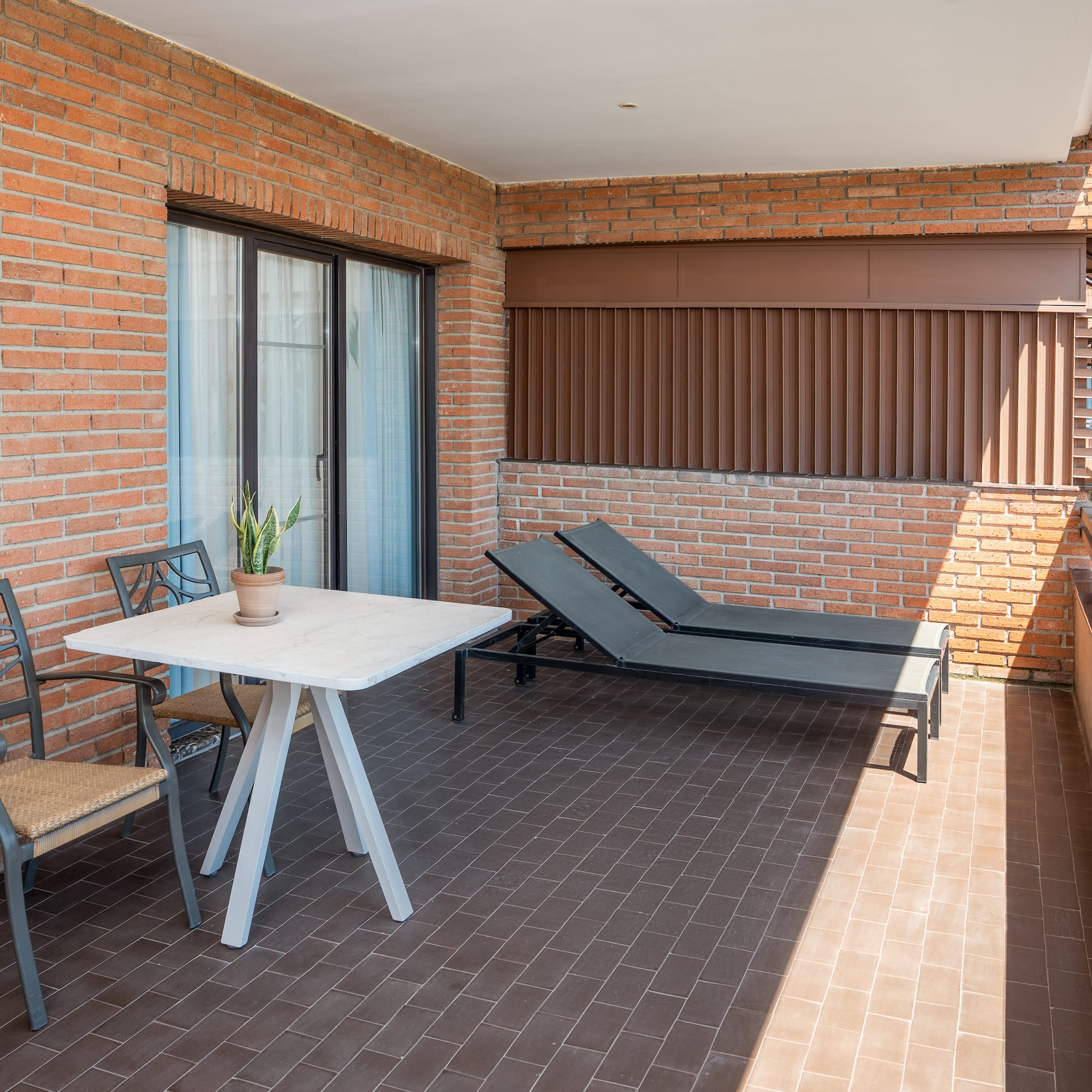 a patio with chairs and a table