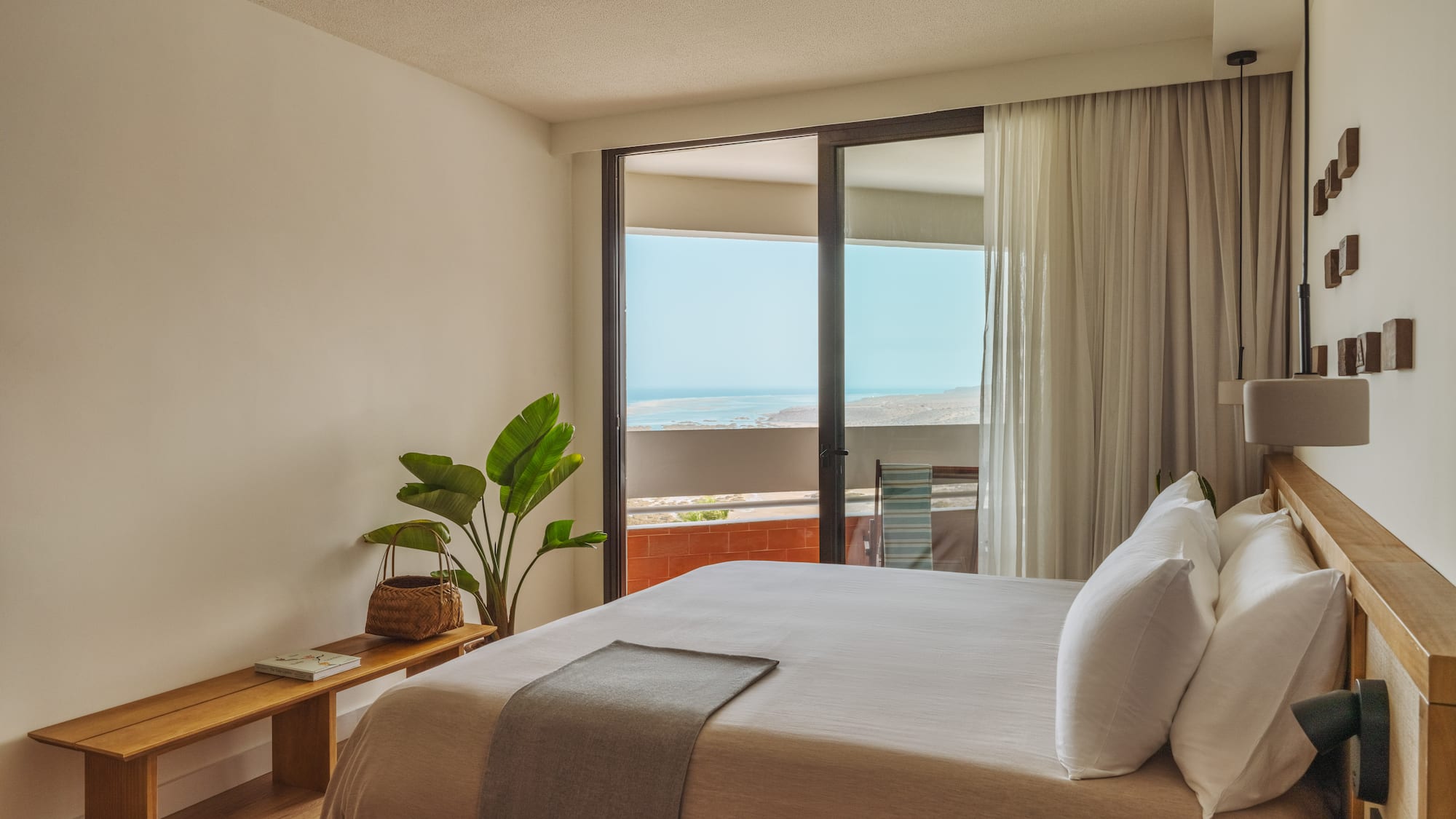 a bedroom with a large bed and a window