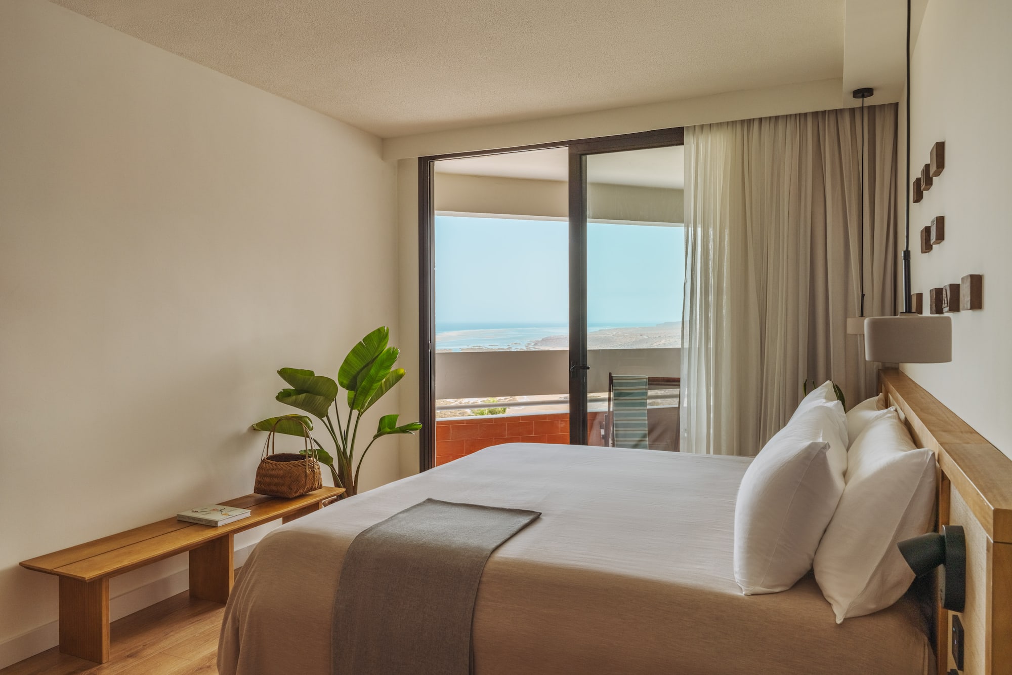 a bedroom with a large bed and a window