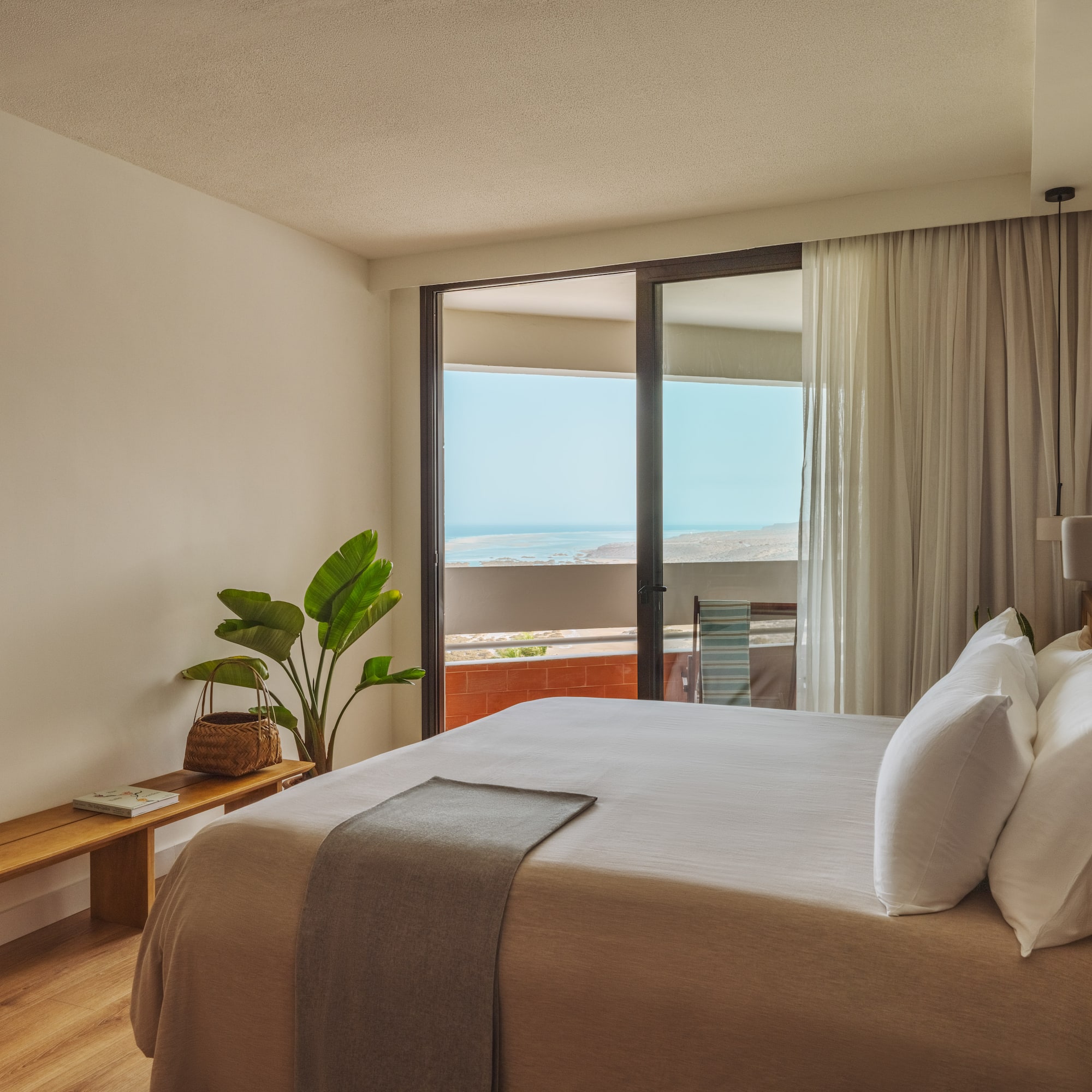 a bedroom with a large bed and a window