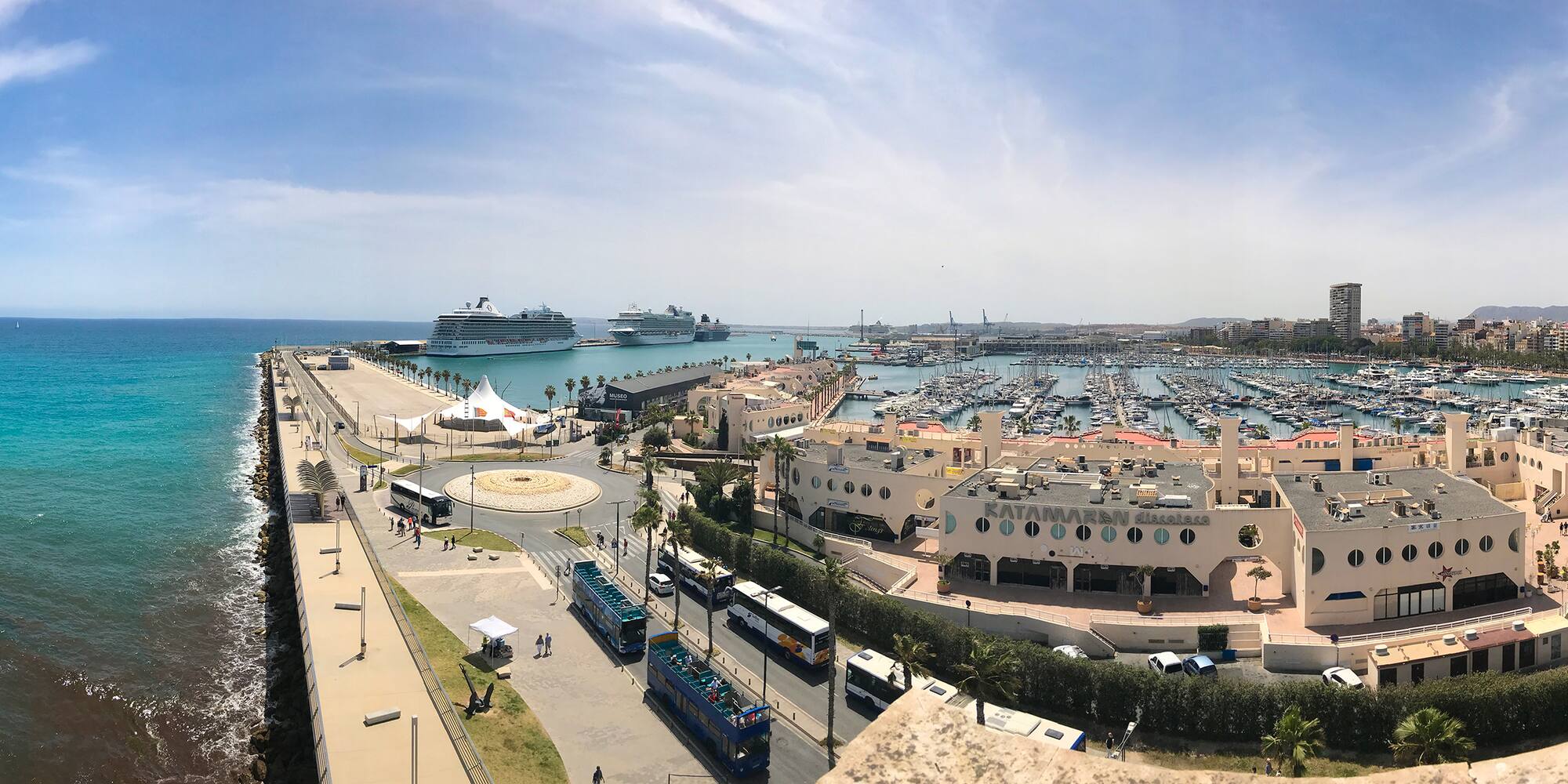 a city with a lot of boats and a body of water