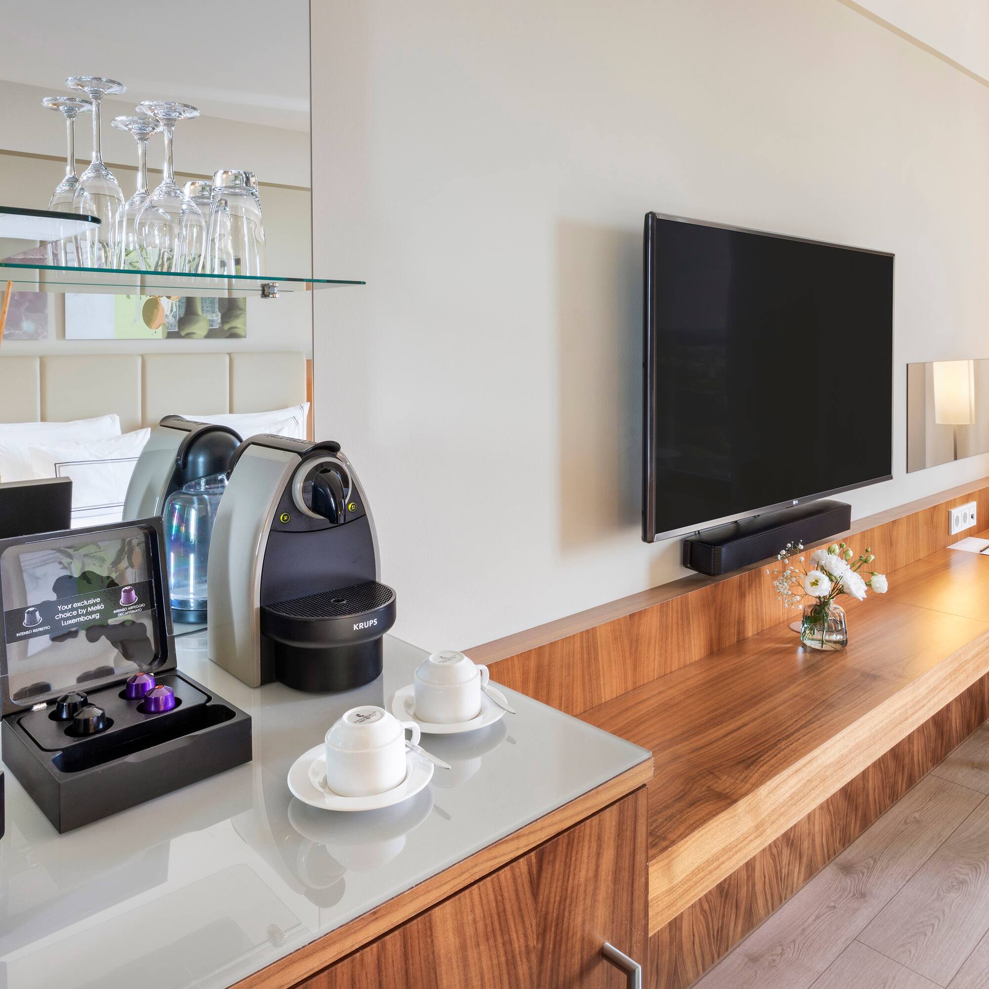 a room with a television and a coffee machine
