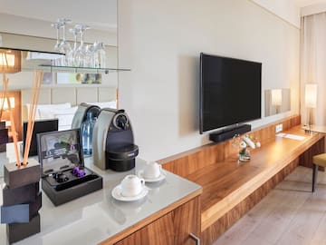 a room with a television and a coffee machine