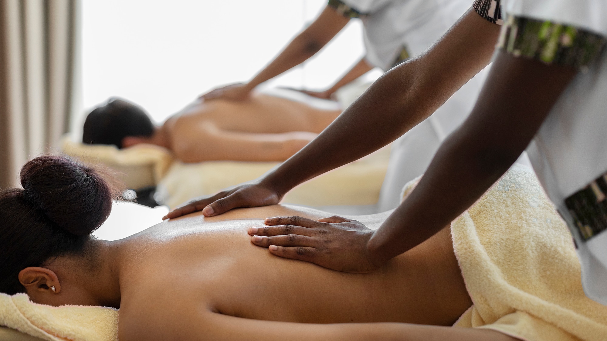 a man and woman receiving a back massage