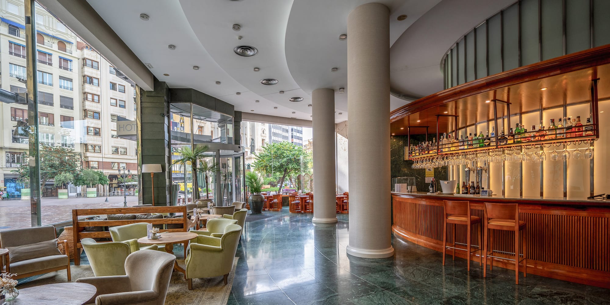 a large room with a bar and chairs
