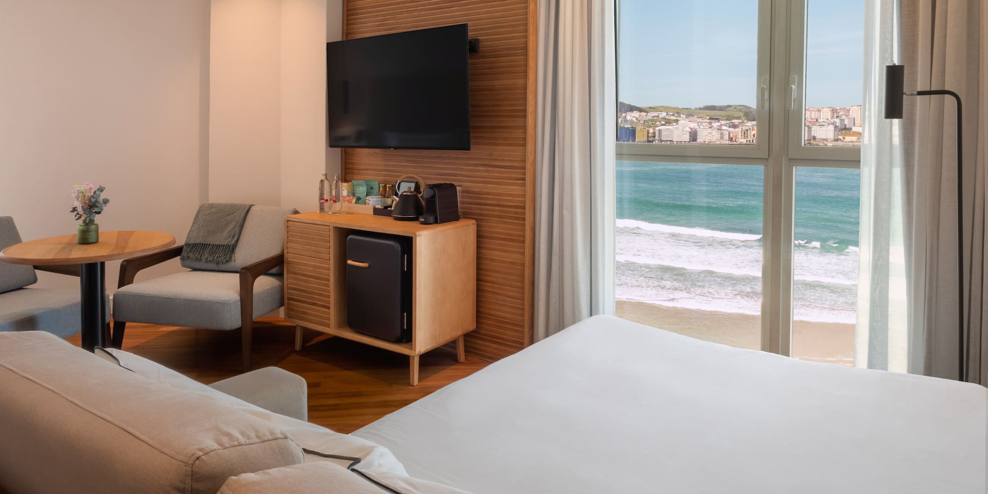 a room with a television and a beach view