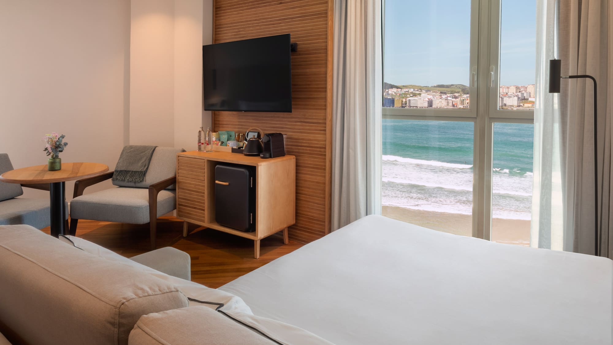 a room with a television and a beach view