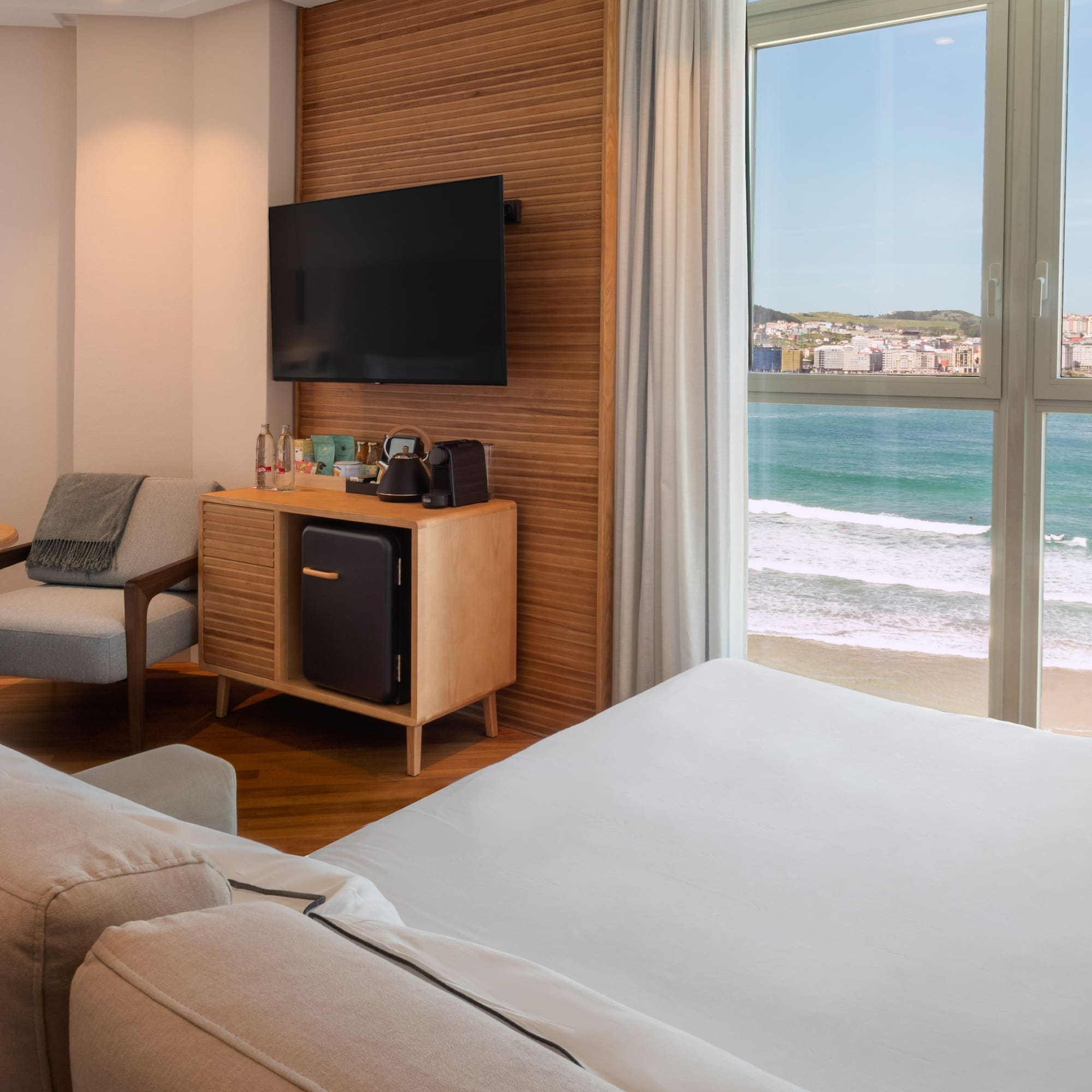 a room with a television and a beach view