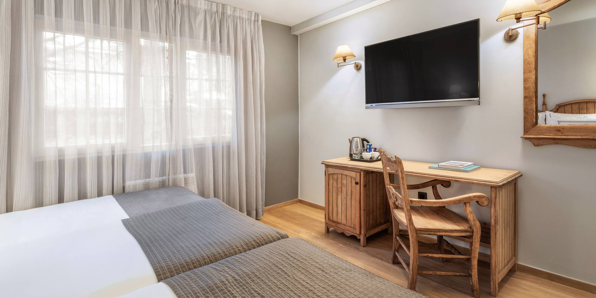 a room with a tv and a bed