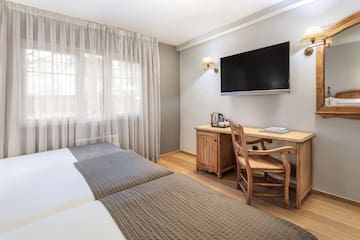 a room with a tv and a bed