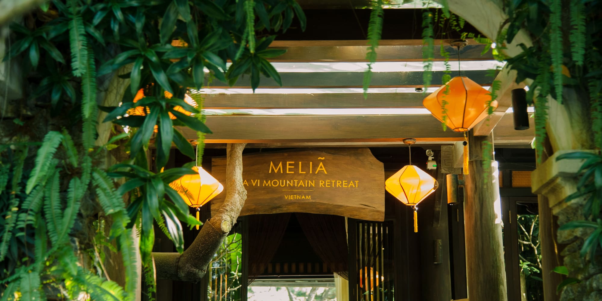 a sign with lanterns from the ceiling