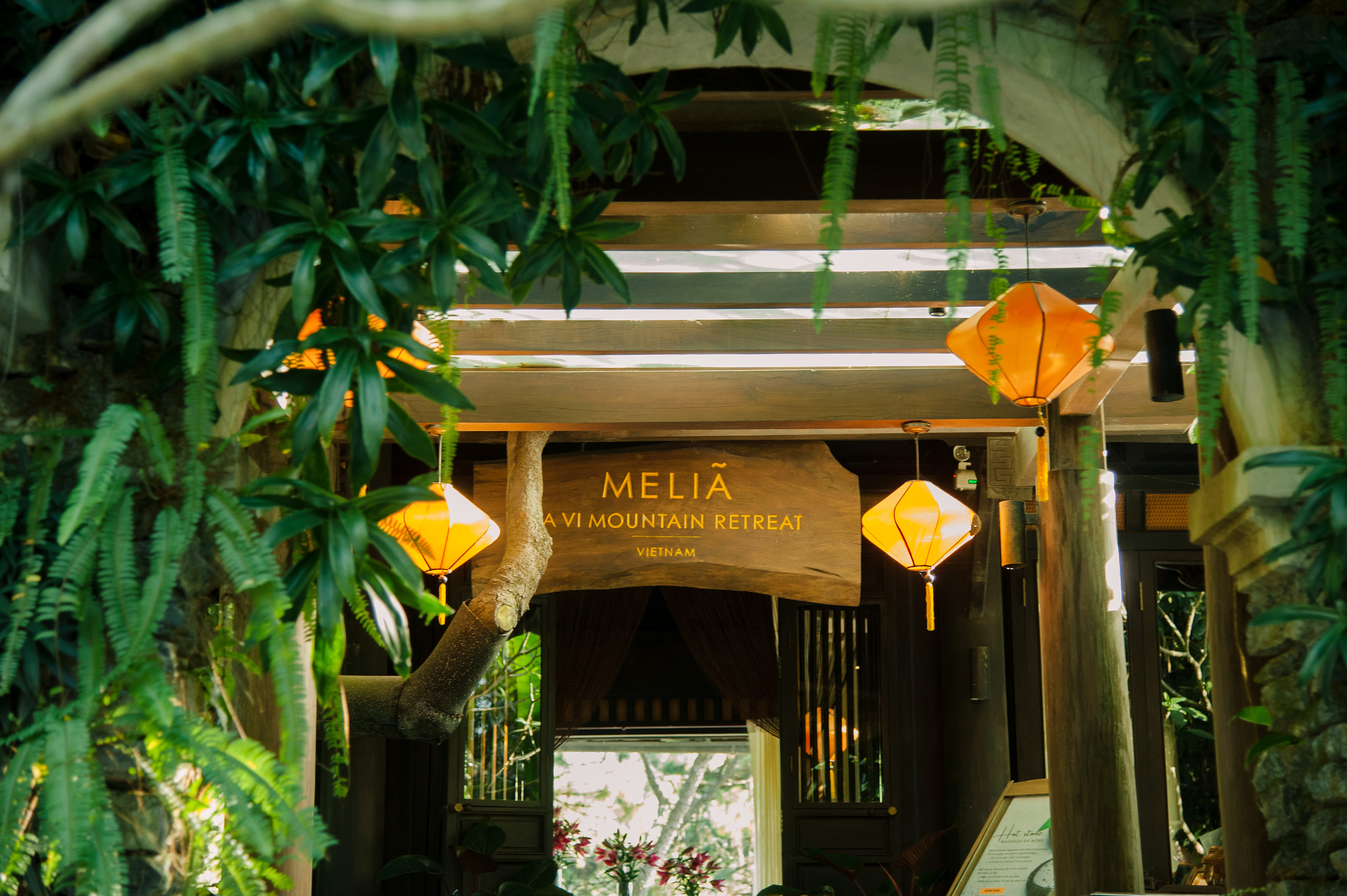 a sign with lanterns from the ceiling
