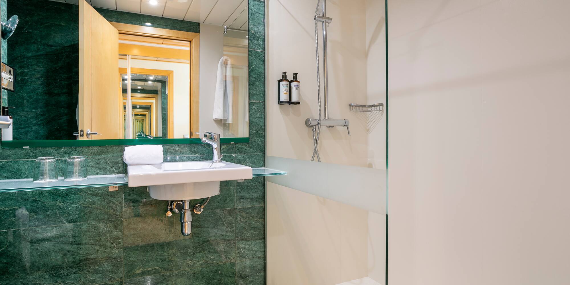 a bathroom with a glass shower and sink