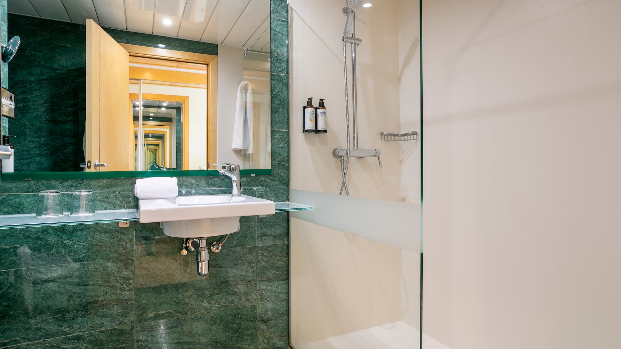a bathroom with a glass shower and sink