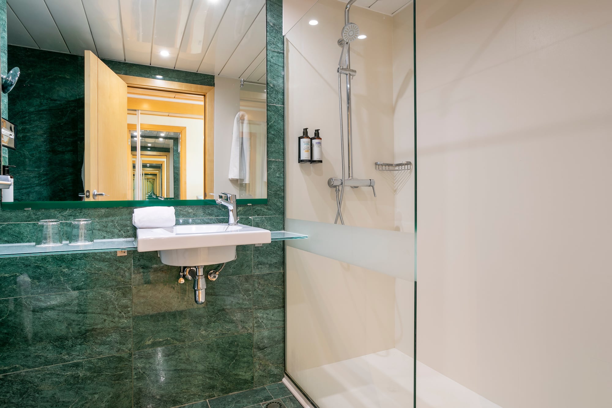 a bathroom with a glass shower and sink