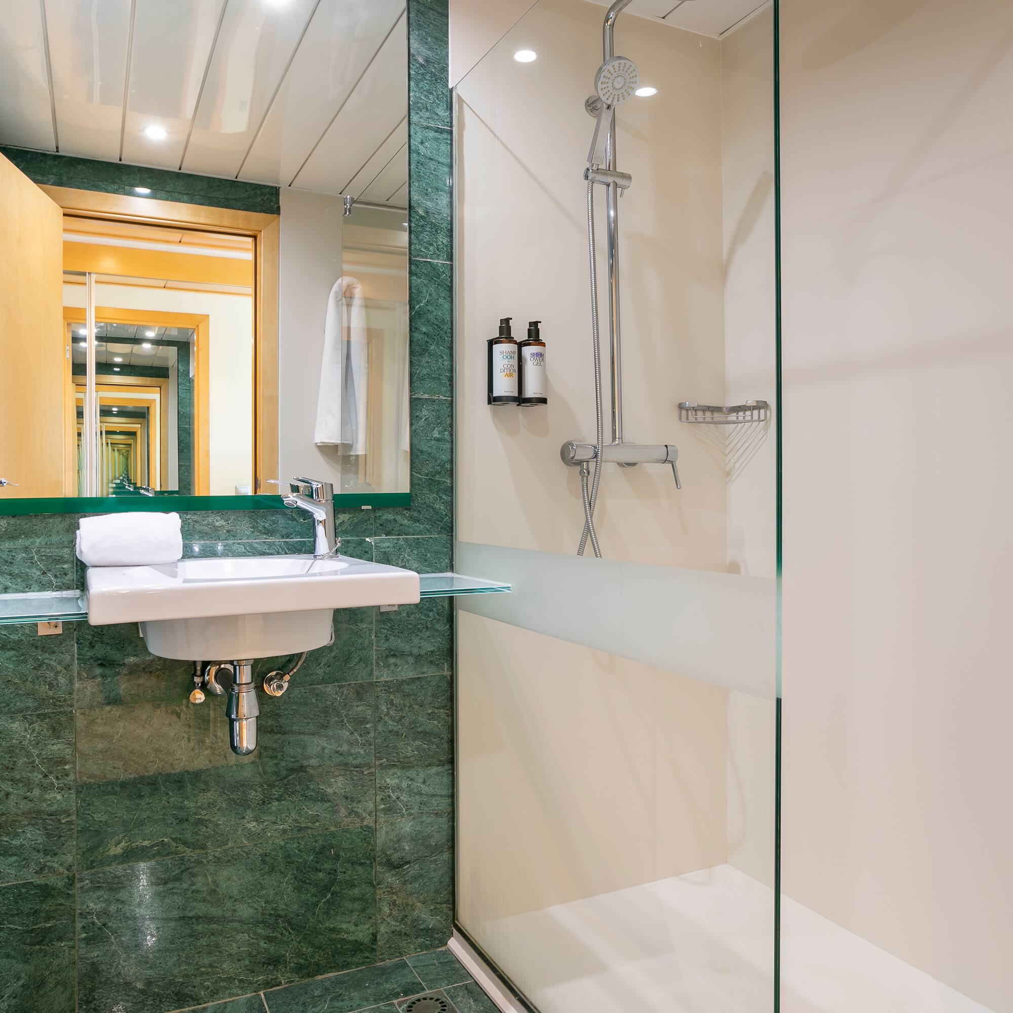 a bathroom with a glass shower and sink