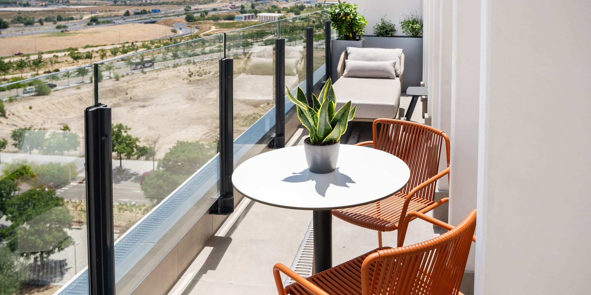 a balcony with chairs and a table