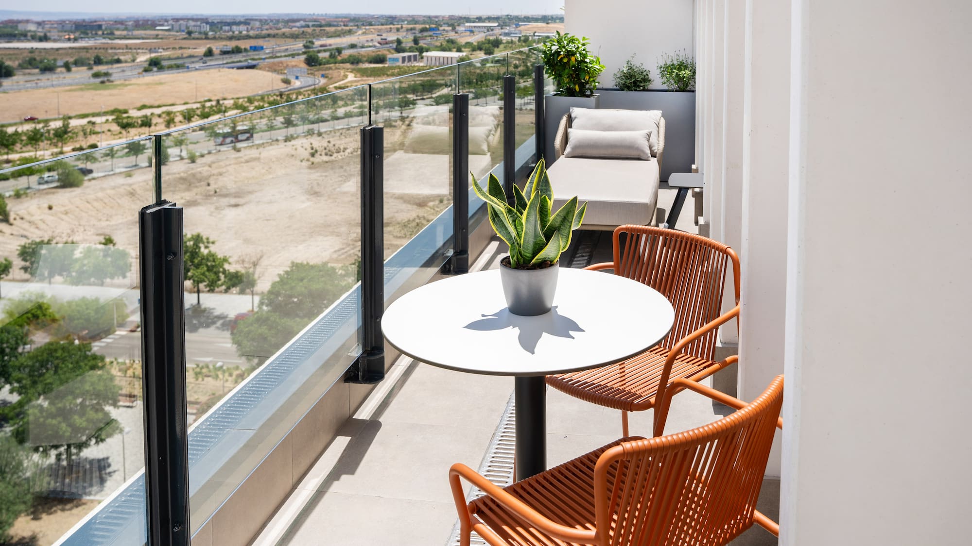 a balcony with chairs and a table