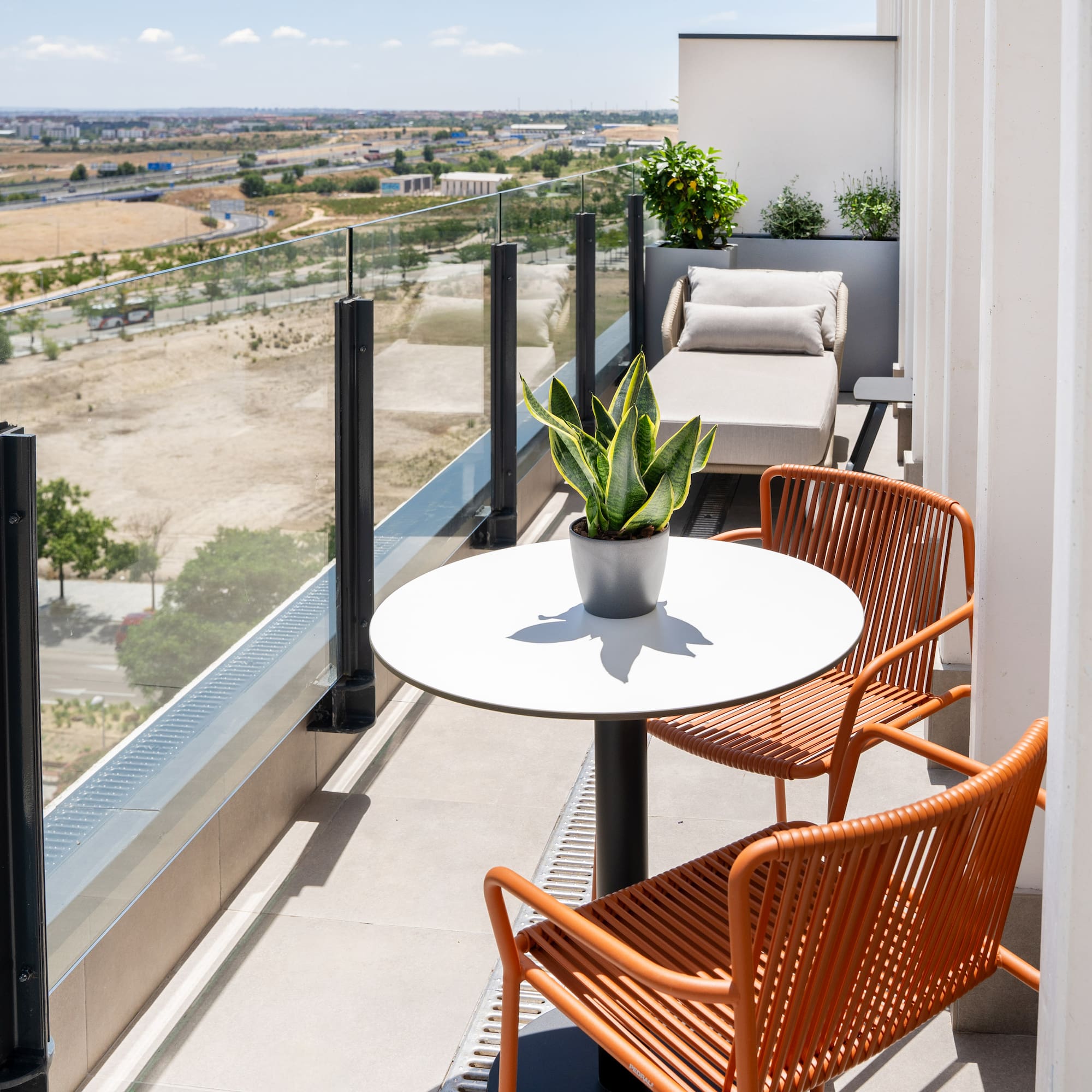 a balcony with chairs and a table