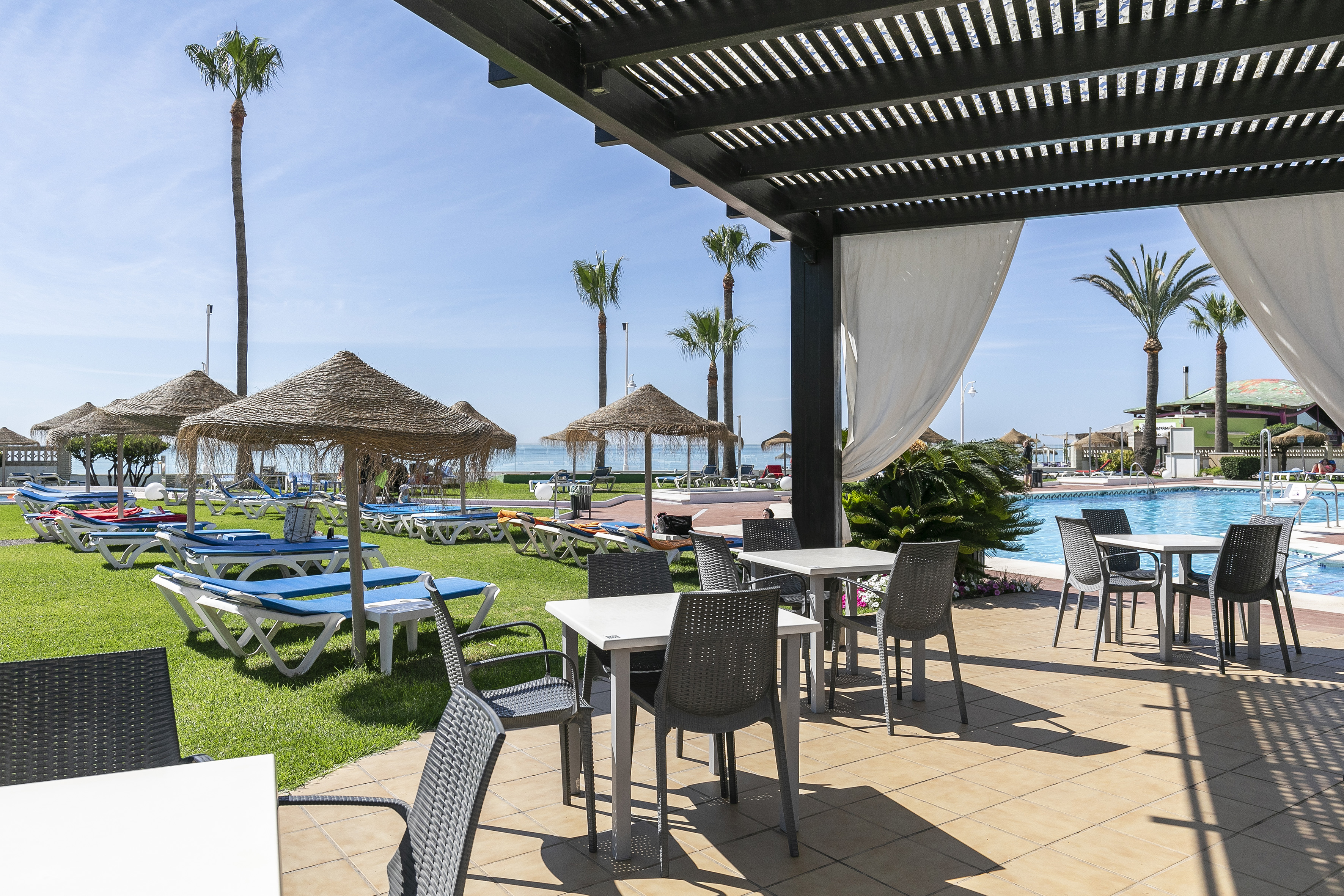 a pool with chairs and umbrellas