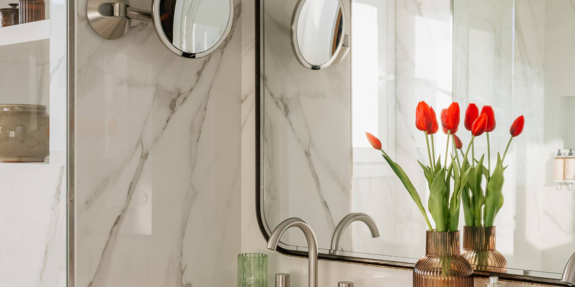 a bathroom with a mirror and flowers