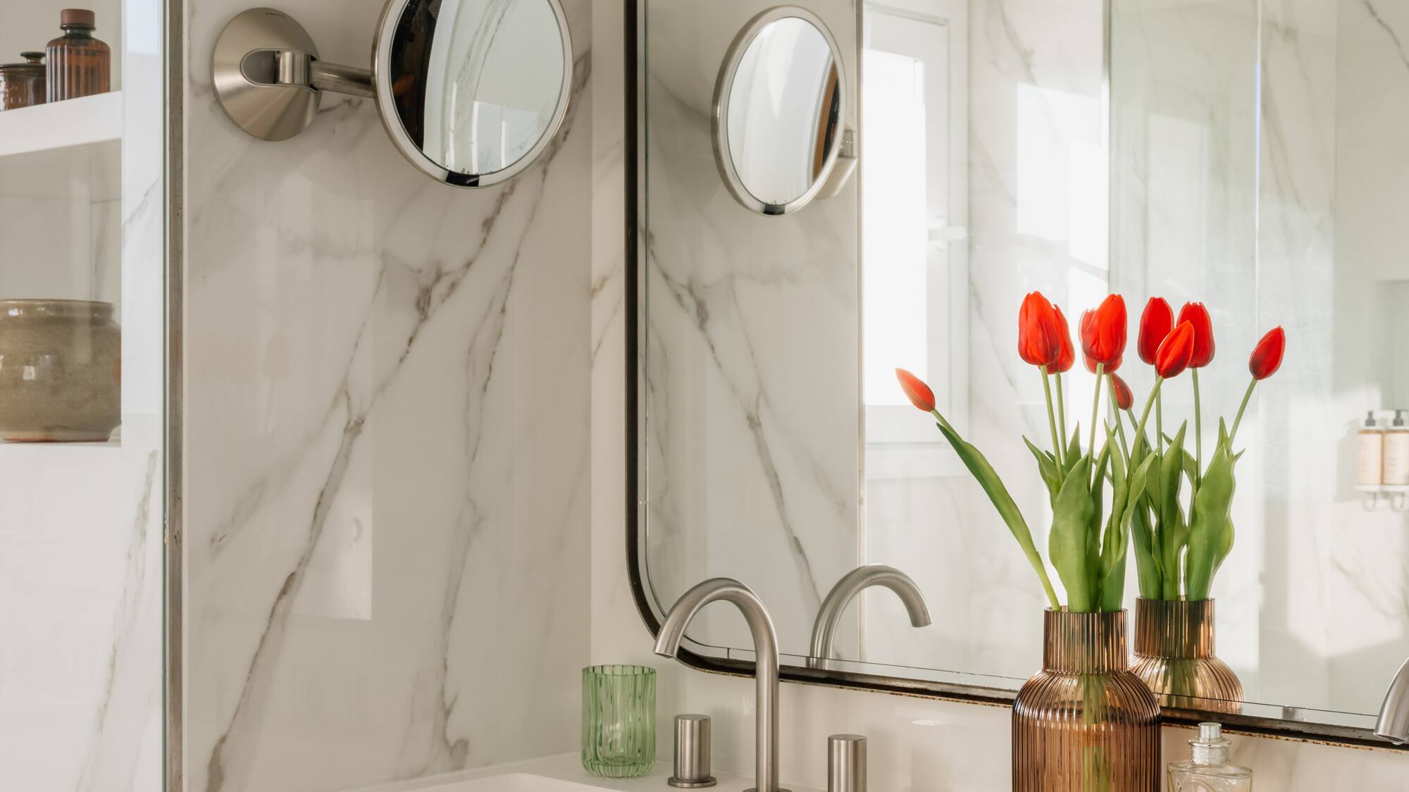 a bathroom with a mirror and flowers