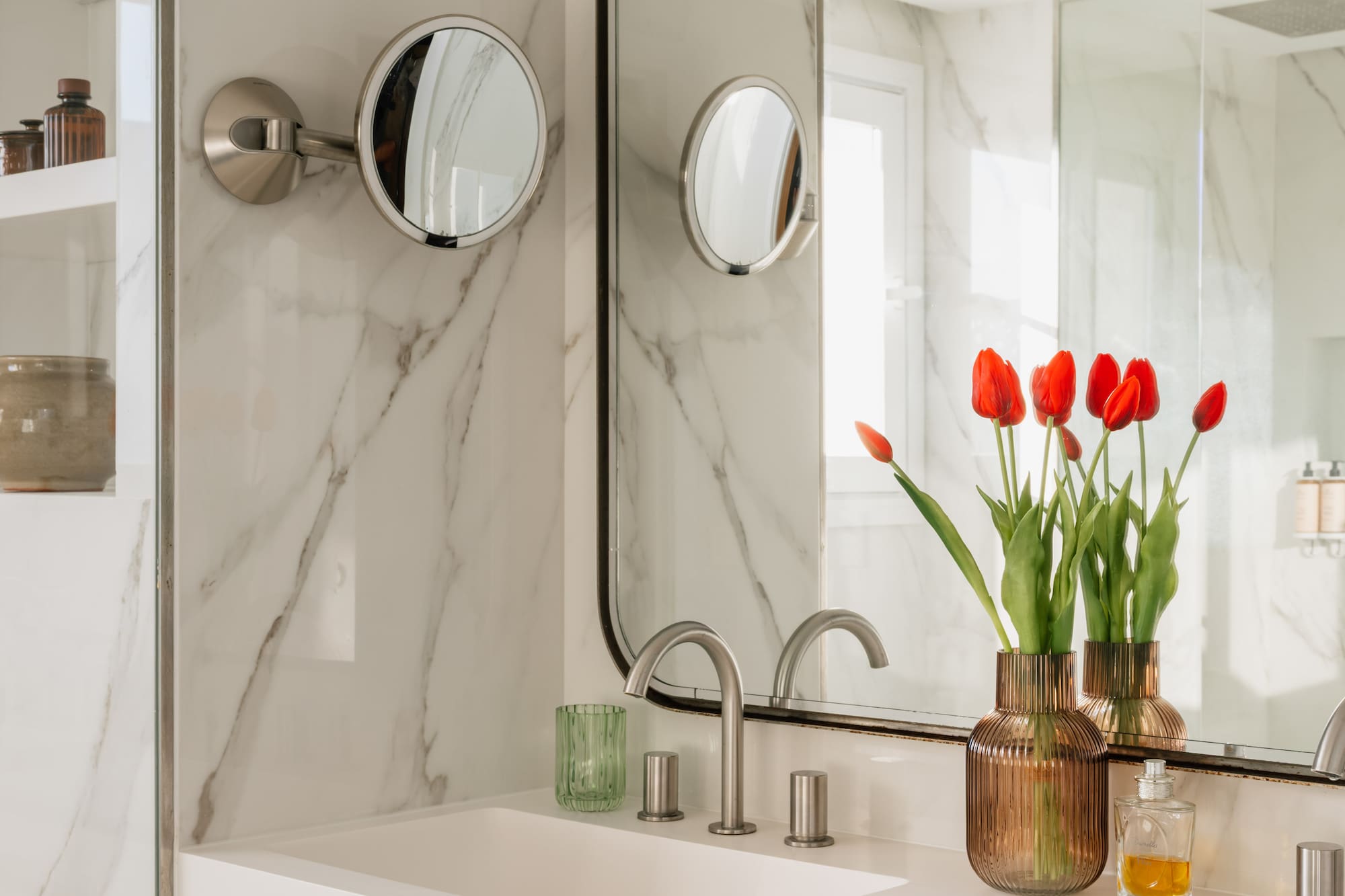 a bathroom with a mirror and flowers