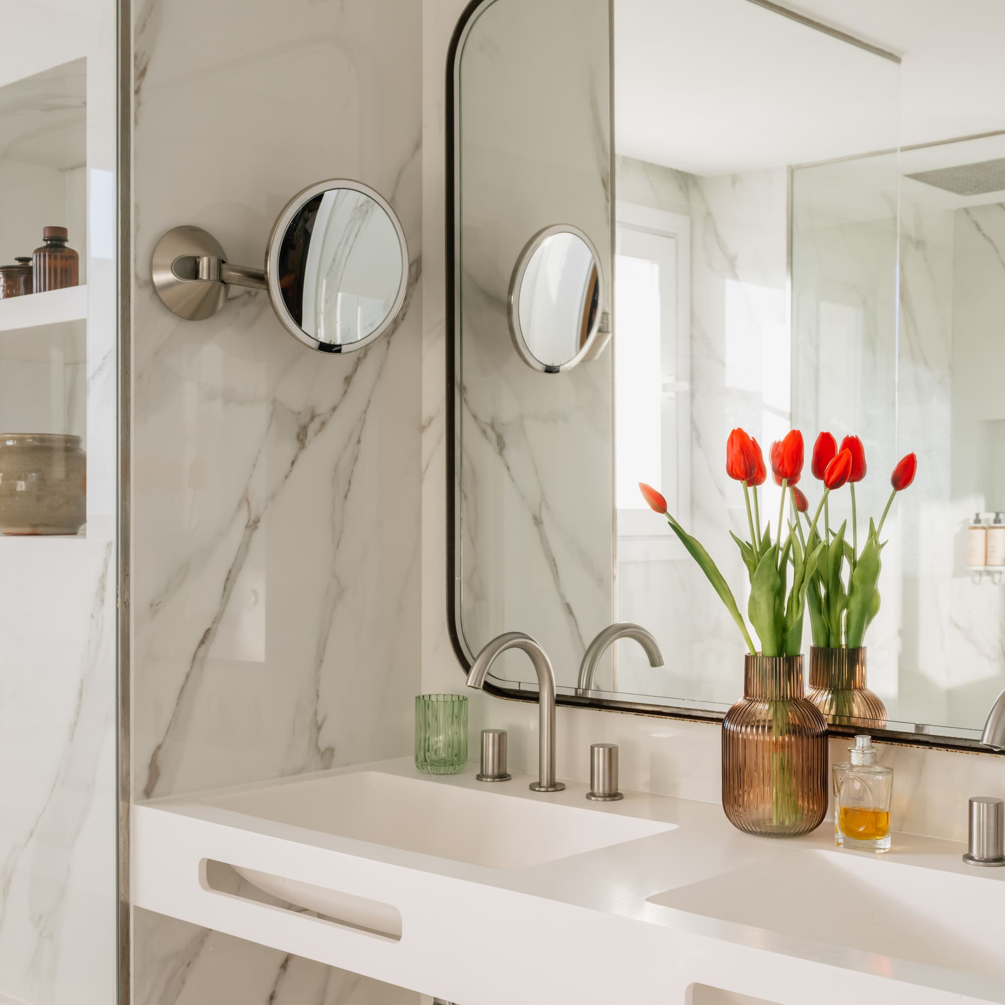 a bathroom with a mirror and flowers