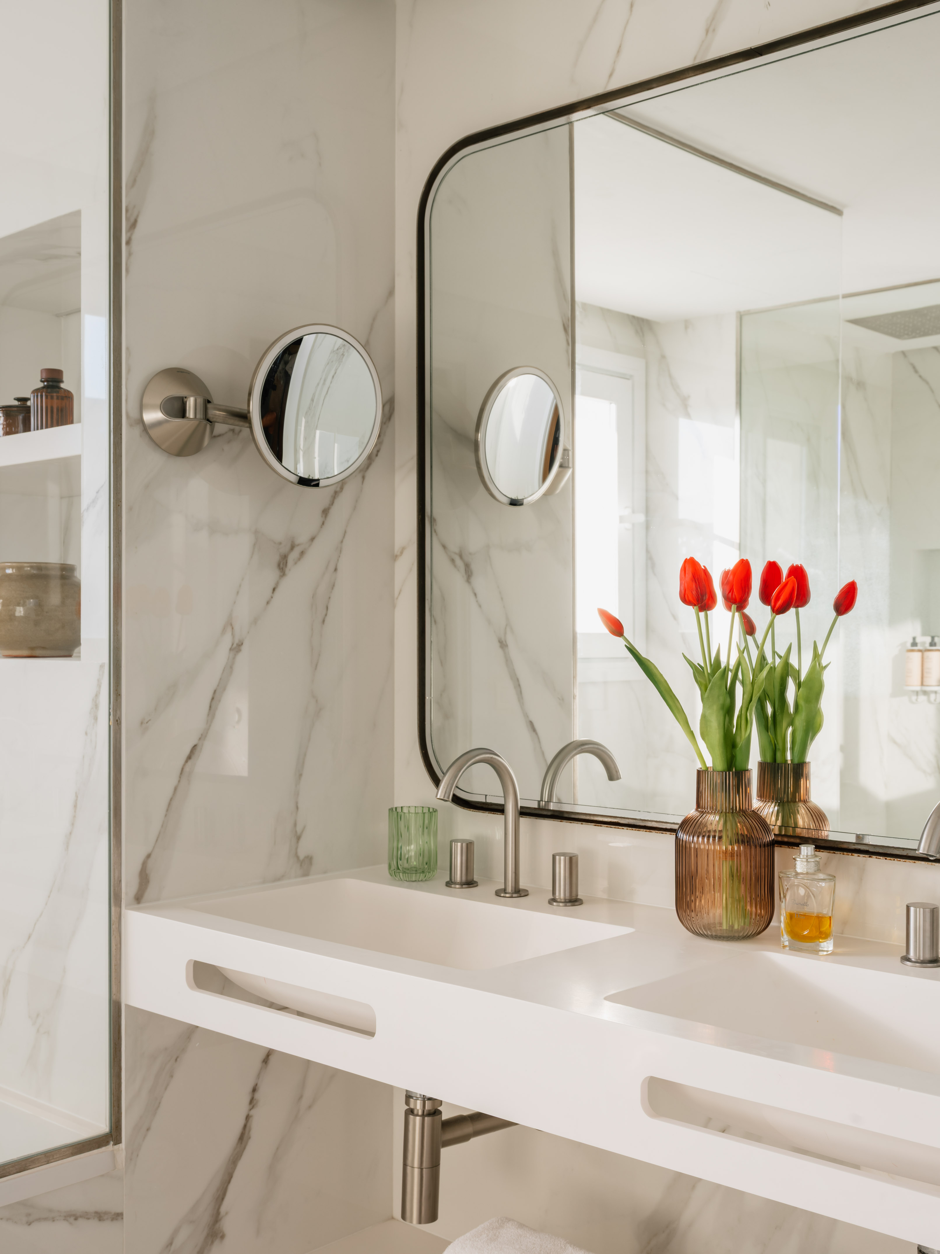 a bathroom with a mirror and flowers