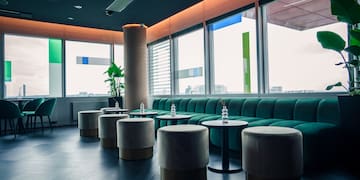 a room with green couches and tables
