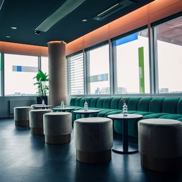 a room with green couches and tables