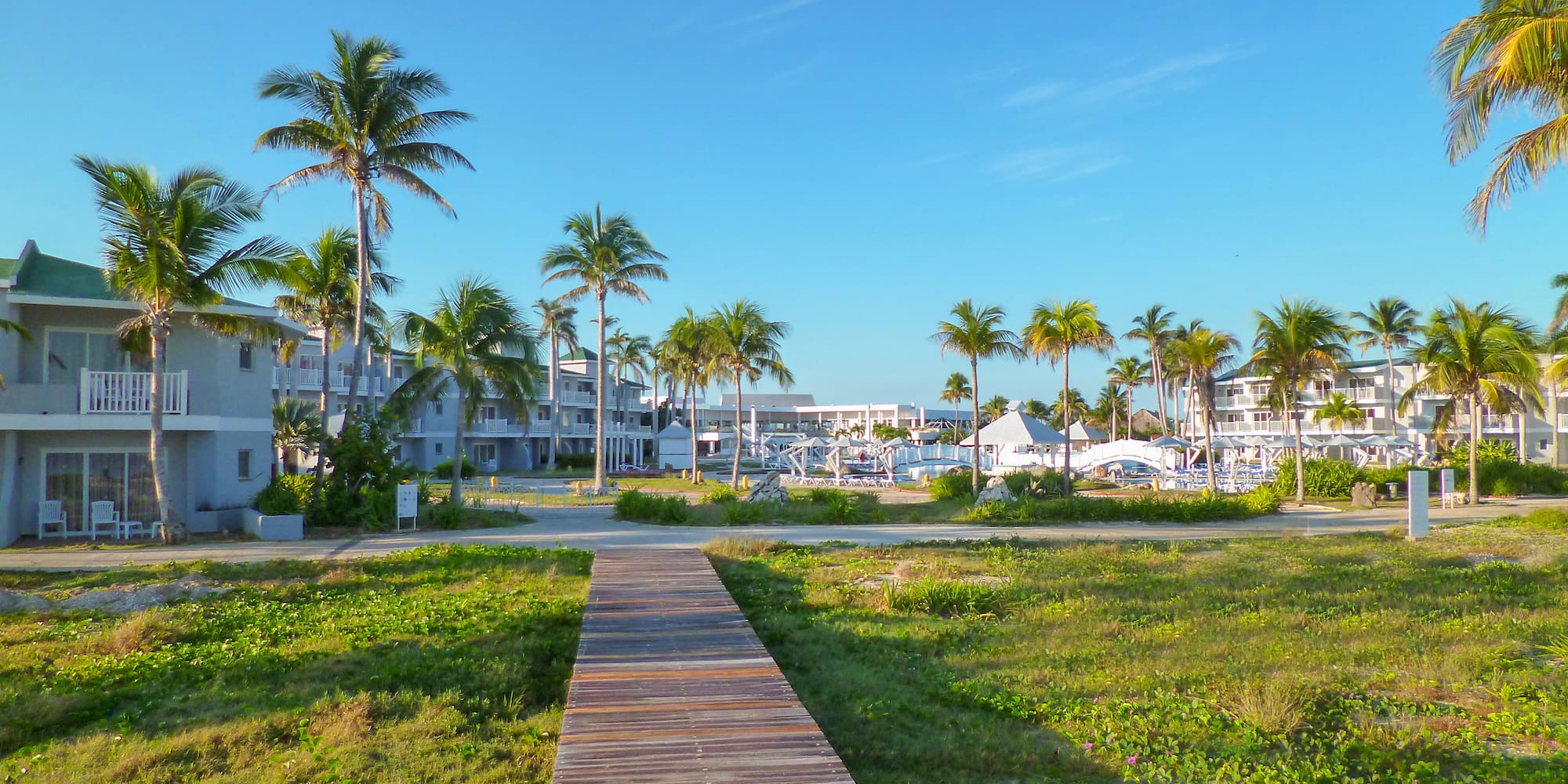 a wooden walkway leading to a beach