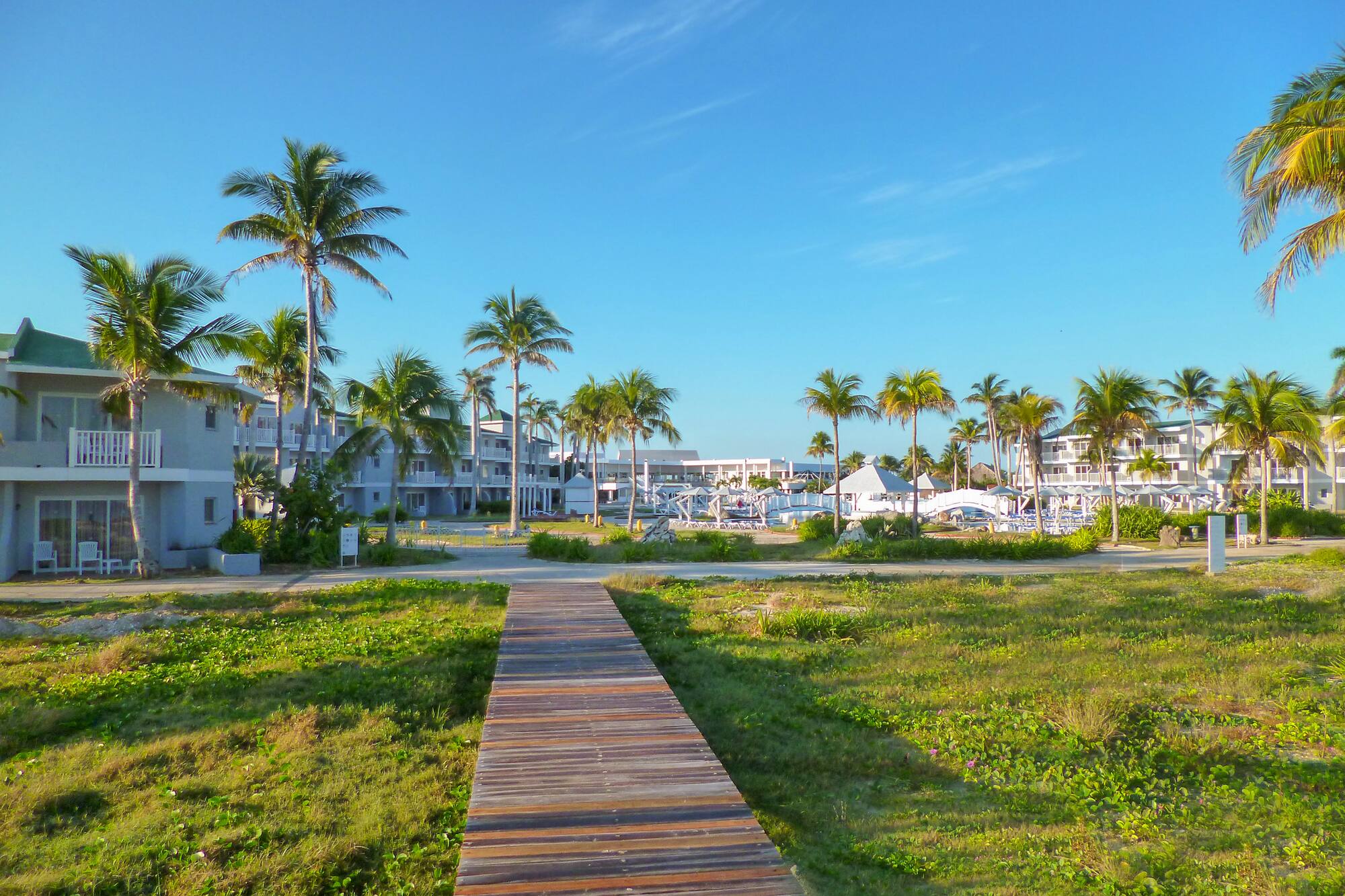 a wooden walkway leading to a beach