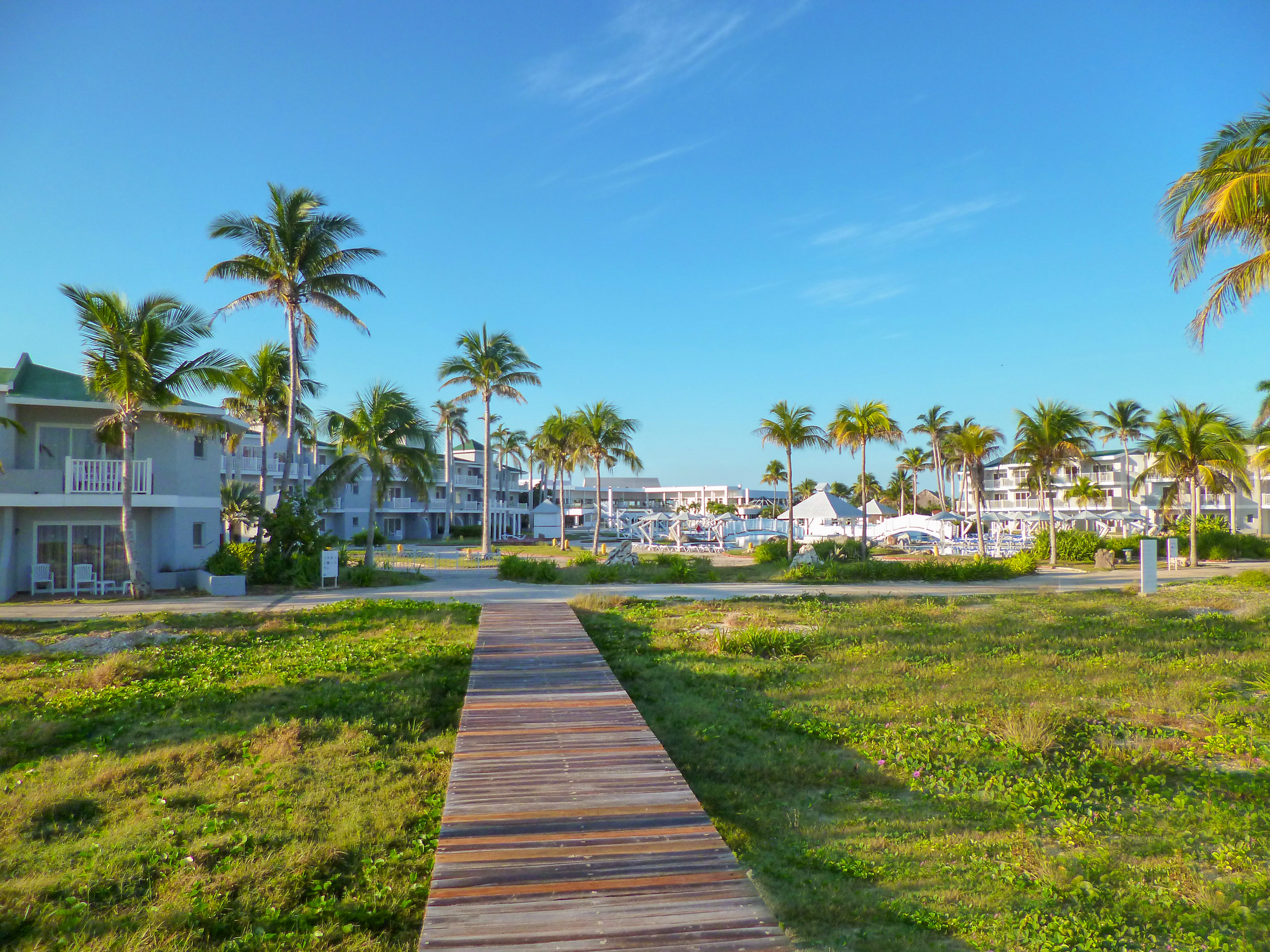 a wooden walkway leading to a beach