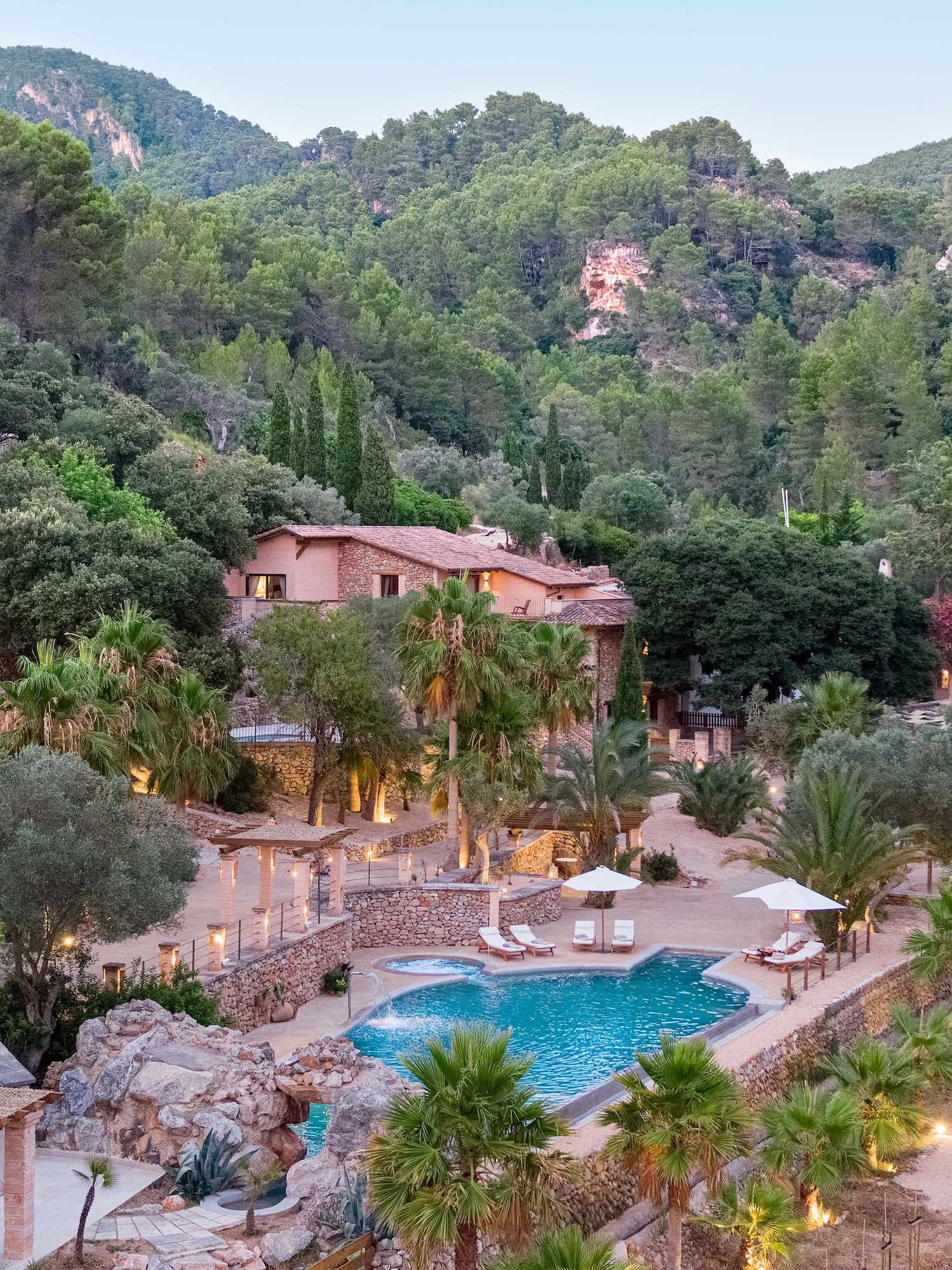 a pool surrounded by trees and buildings
