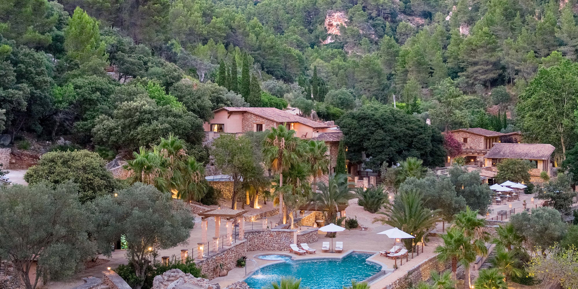 a pool surrounded by trees and buildings