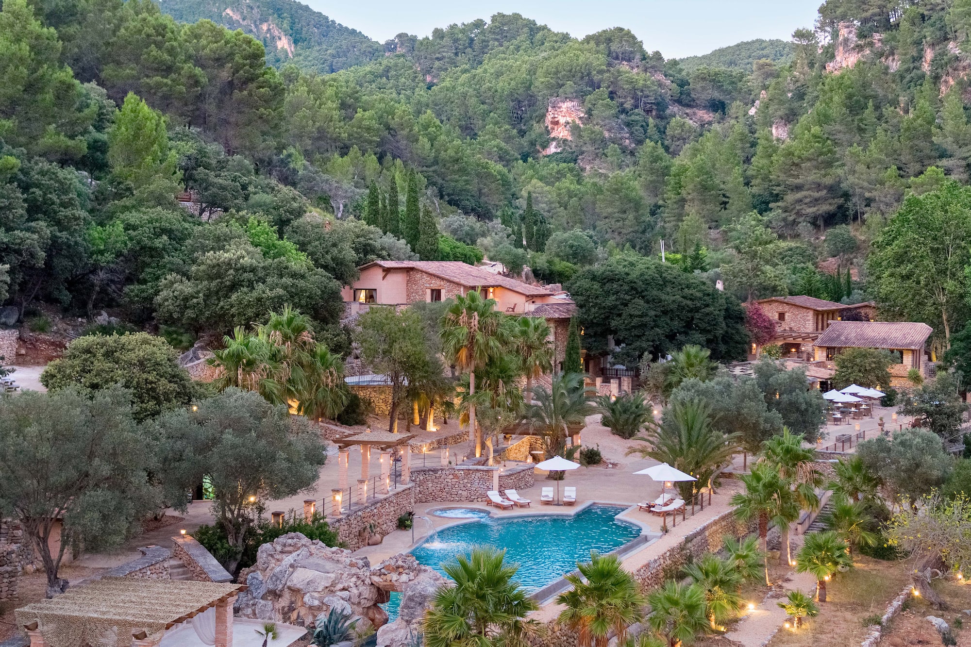 a pool surrounded by trees and buildings